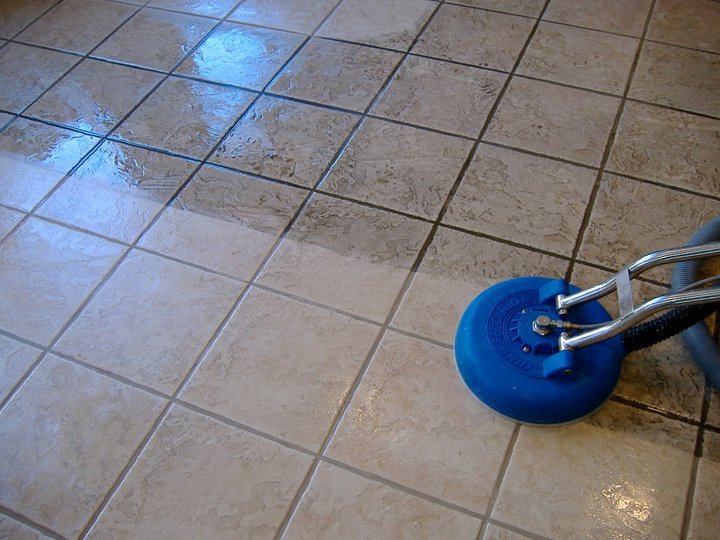 Technician cleaning grout on Dubai tile floor
